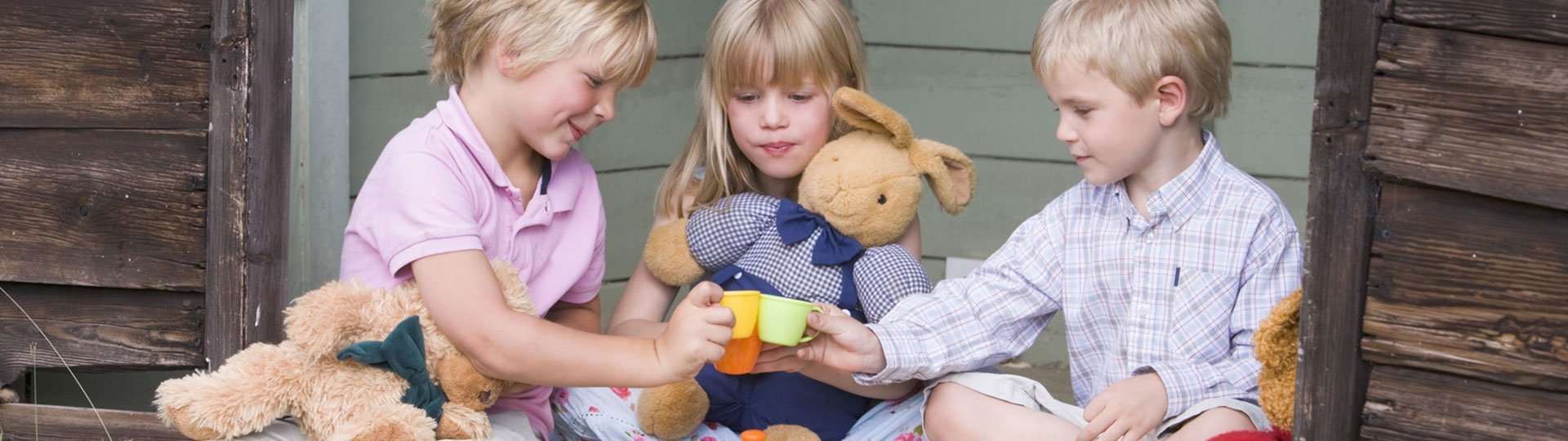Kid's outdoor furniture Children outside having a tea party.