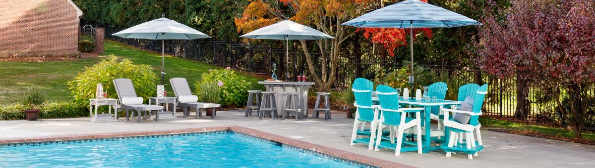Tables and Umbrellas Lounge chairs, bar and stools, and dining table and chairs, all with umbrellas.